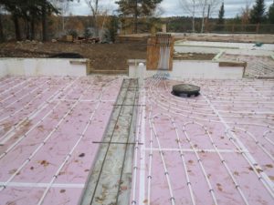 hot water in floor heating tubes, custom lake home construction huisman