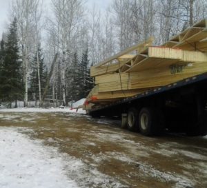 Roof truss deliver for custom lake home huisman concepts ely mn