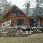 Cedar and stone small cabin, flat stone landscaping