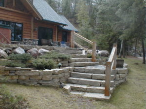 Exterior from lake, stone landscaping