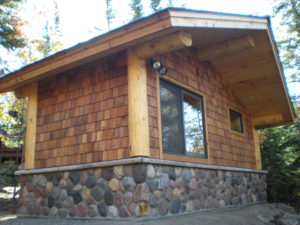Stone and cedar Sauna building