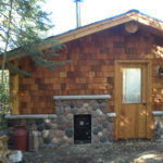 Stone and cedar Sauna building
