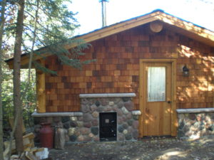 Stone and cedar Sauna building